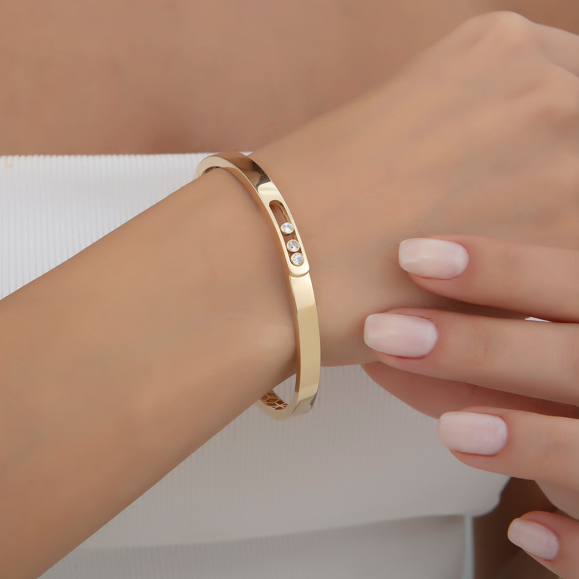 Gold bangle set with three cubic zirconia, detail view — Kavseyn