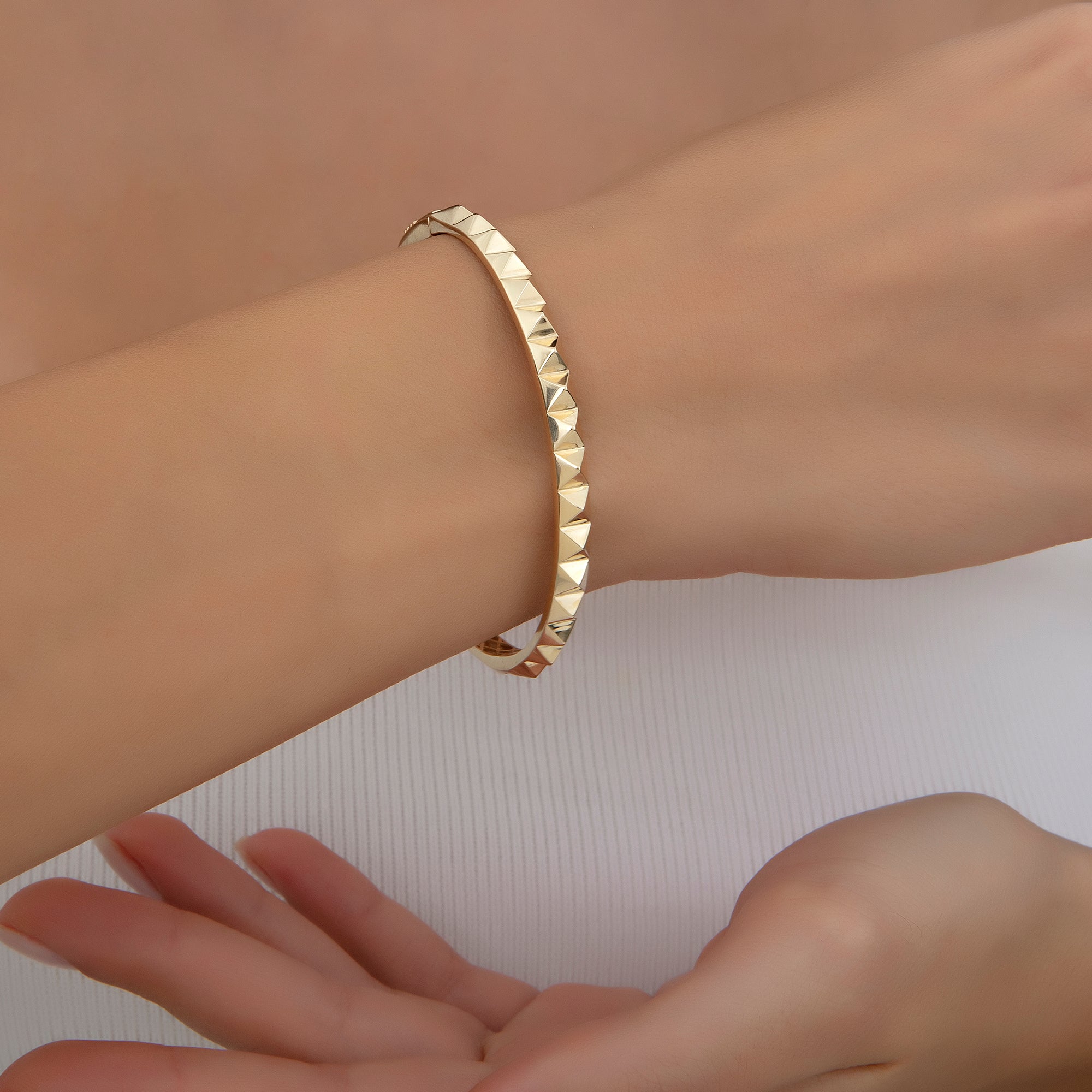 Peaked pyramid stud bangle in gold, detail view — Kavseyn