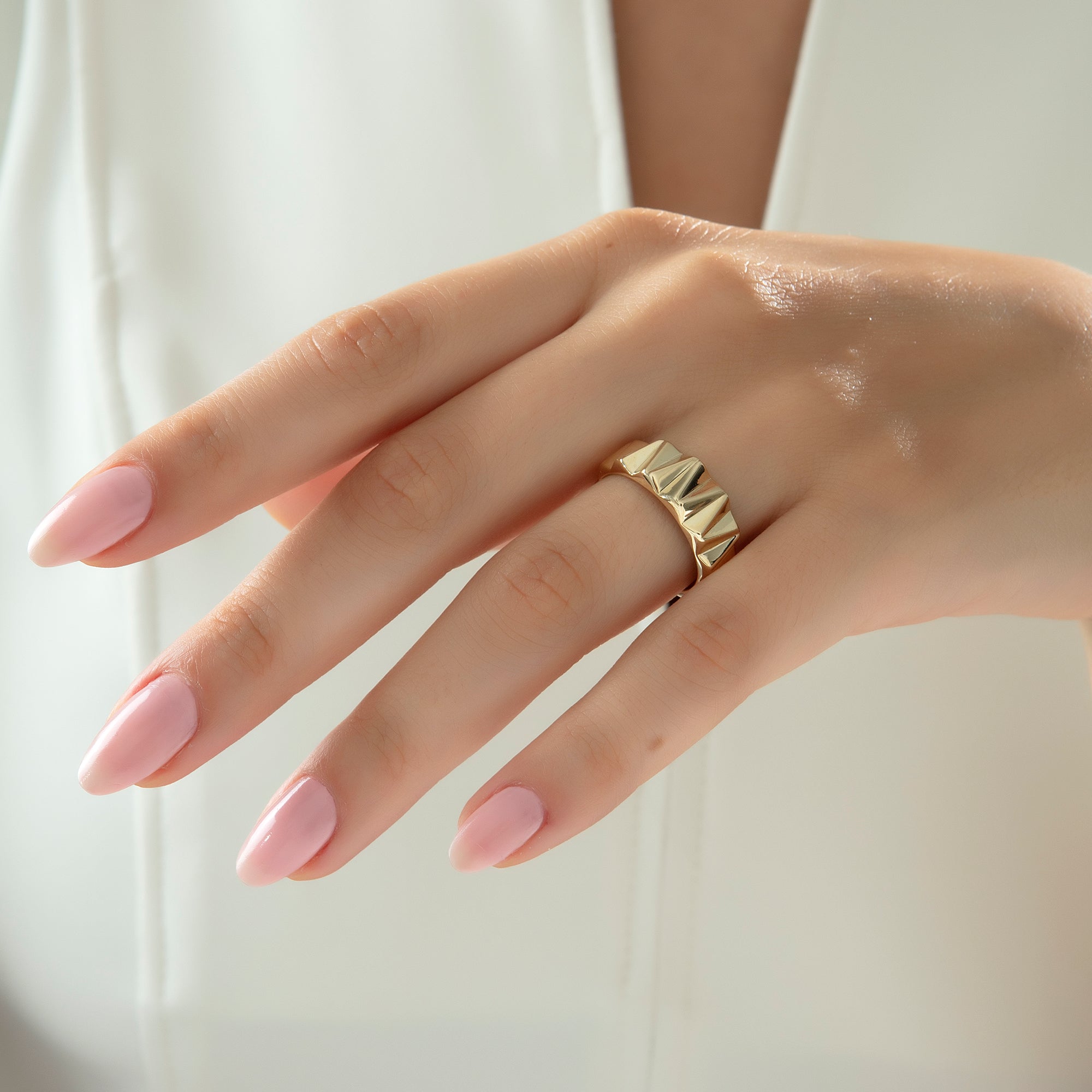 Prism-cut faceted gold band ring, detail view — Kavseyn